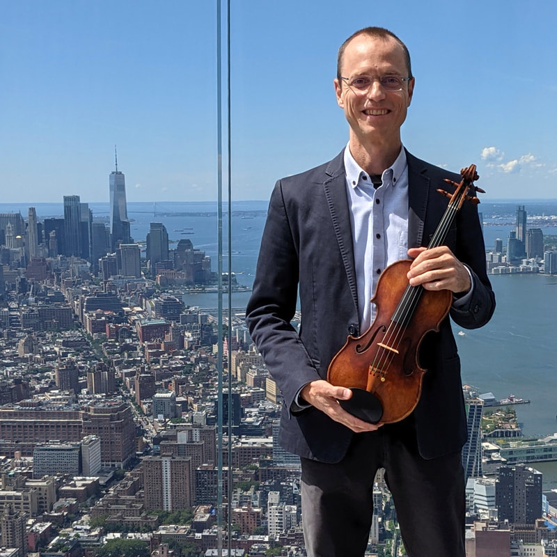 Garrett Fischbach with violin on the Edge at Hudson Yards, New York City